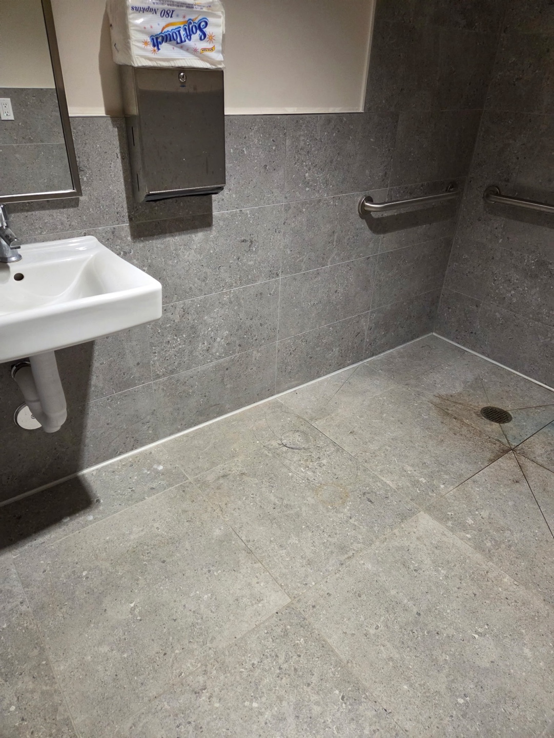 ADA restroom with grab bars and tiled walls