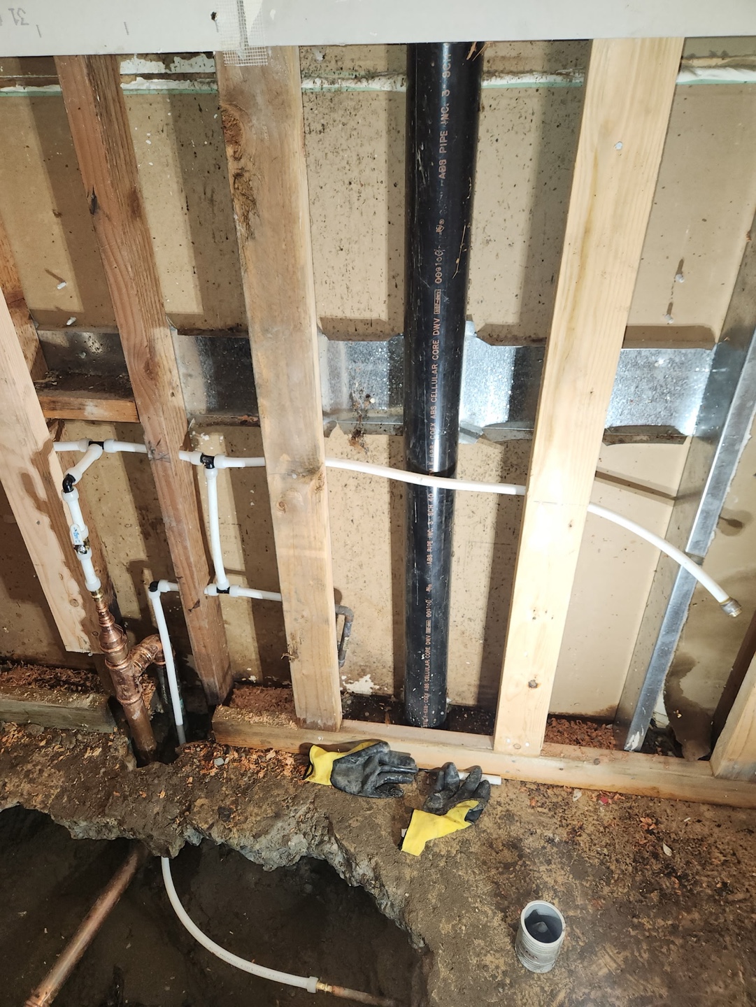 New supply lines run through open floor framing