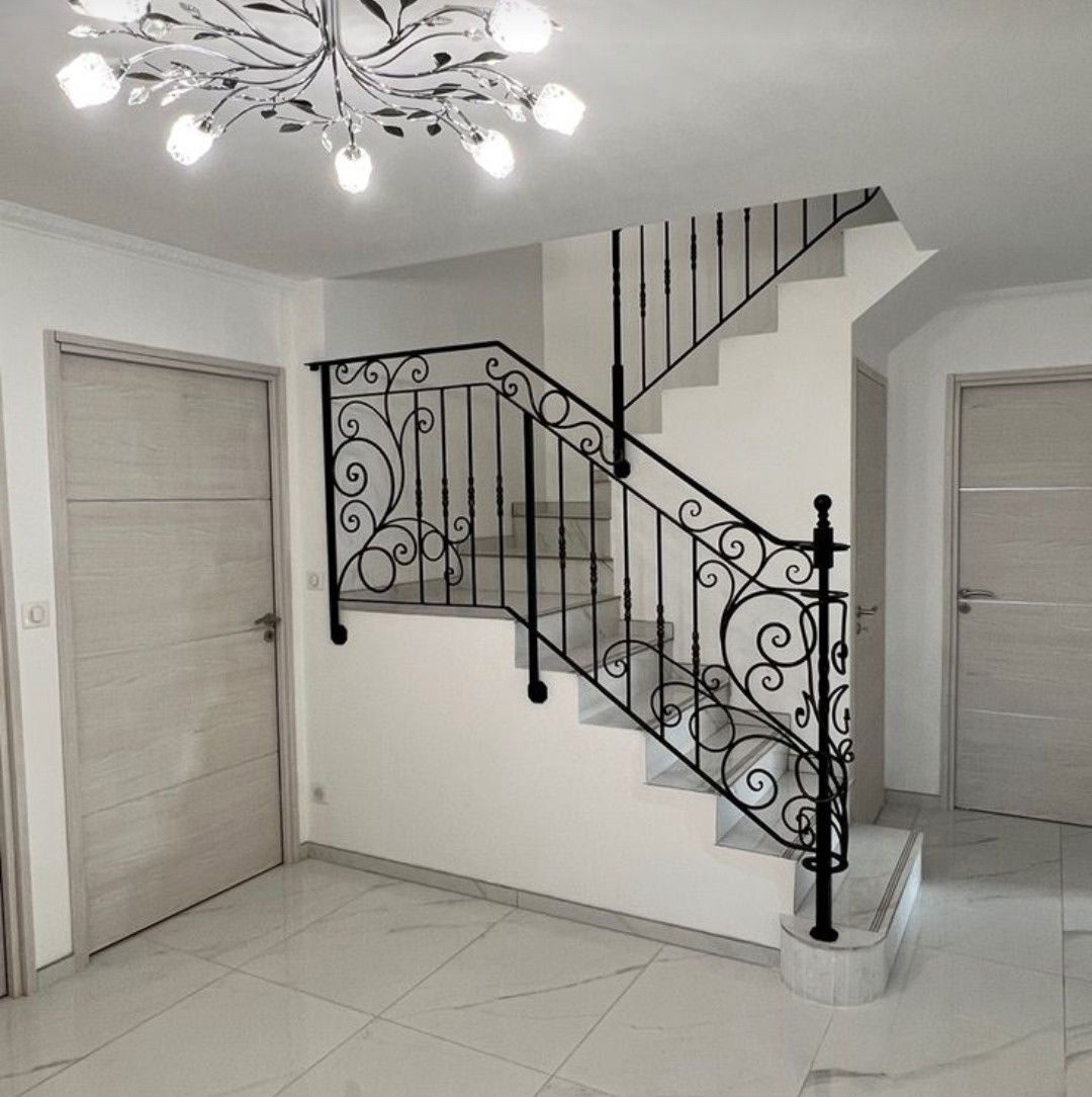 Finished staircase with wrought iron railing