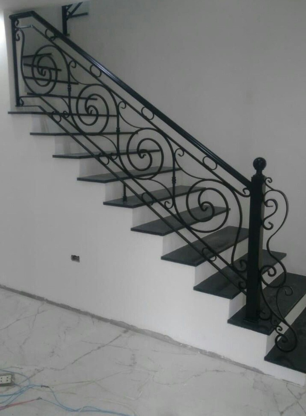 Iron scrollwork stair railing detail