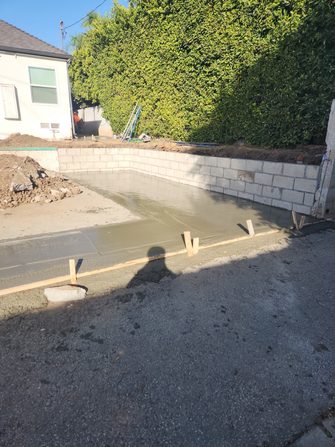 Retaining wall with fresh concrete placed behind it