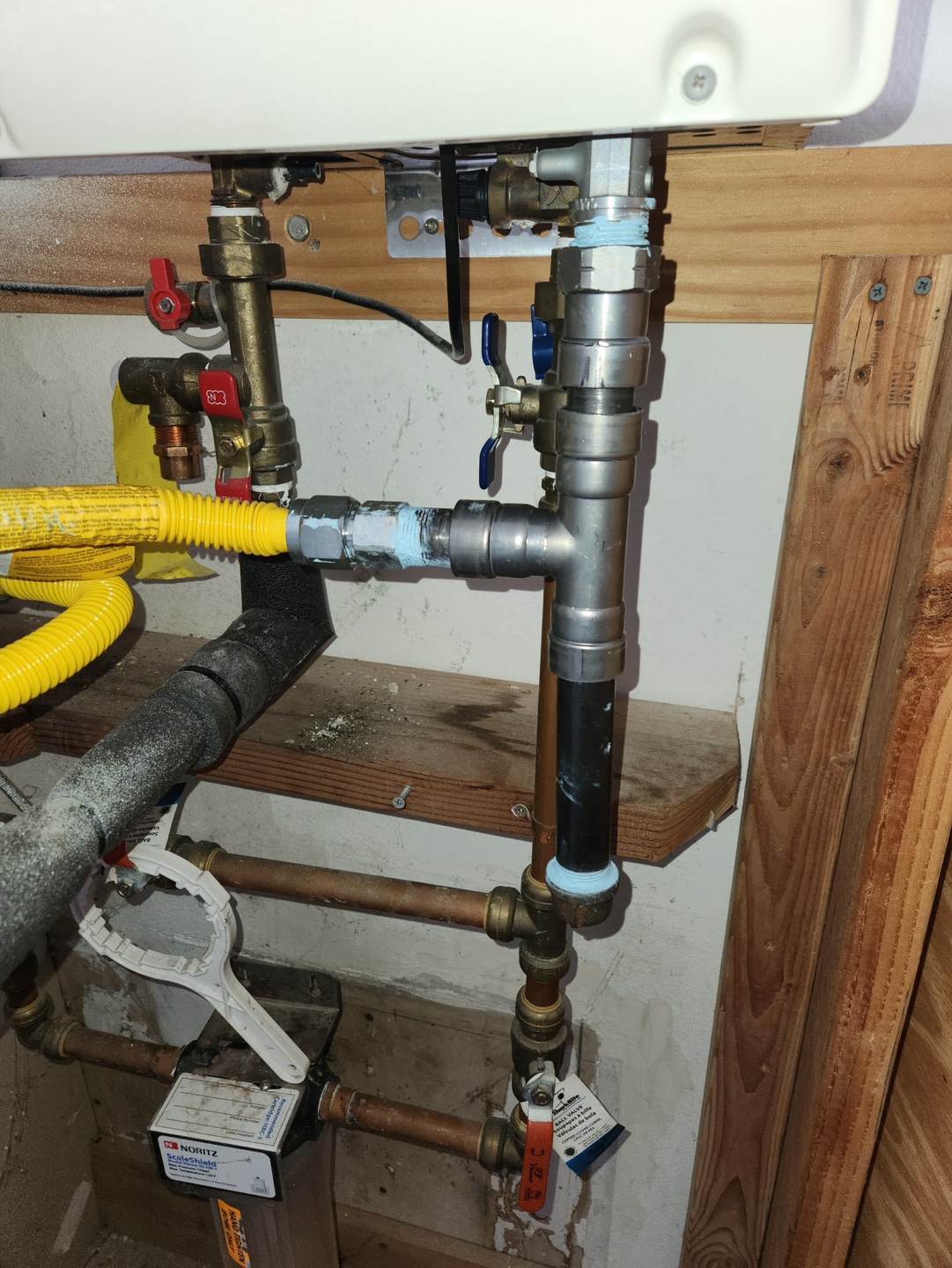 Supply and gas piping reworked beneath a sink
