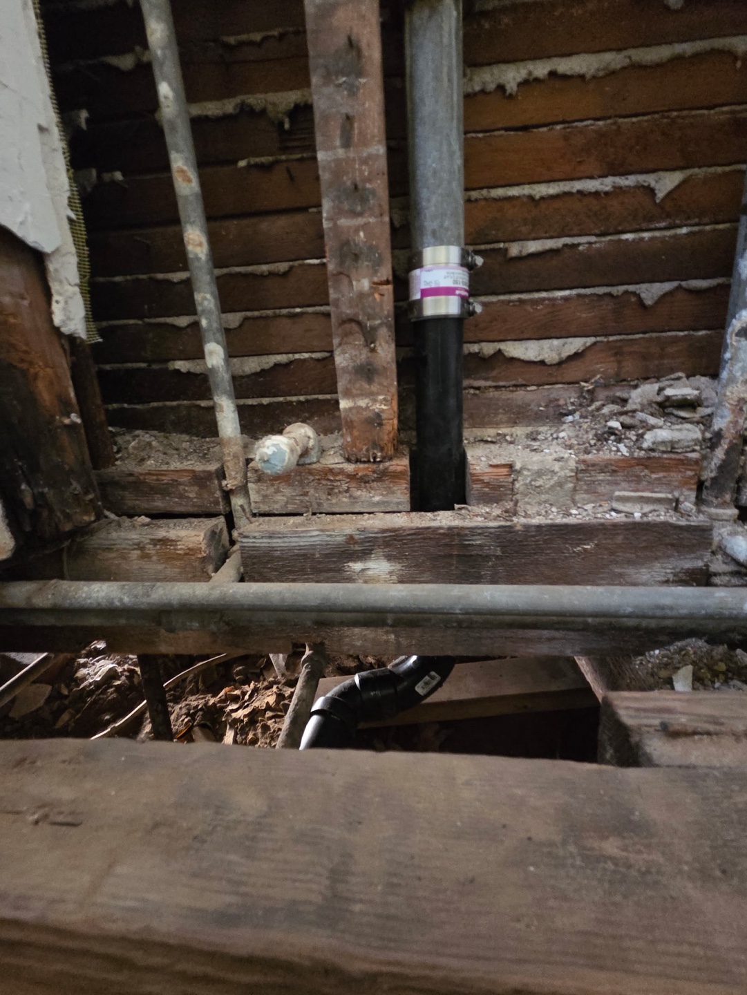 Wall and floor opened to replace a failing cast iron drain